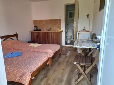 a bedroom with a bed and a table in it at Stefanović - Studio 1 in Inovo