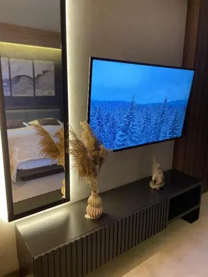a flat screen tv sitting on a shelf in a bedroom at Apartman Kopaonik Woodside 106 in Kopaonik