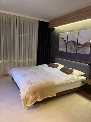 a bedroom with a large bed in a room at Apartman Kopaonik Woodside 106 in Kopaonik