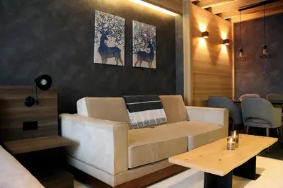 a living room with a couch and a table at Superior Woodside Residences & Spa Kopaonik in Kopaonik