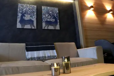 a restaurant with three paintings of deer on the wall at Superior Woodside Residences & Spa Kopaonik in Kopaonik