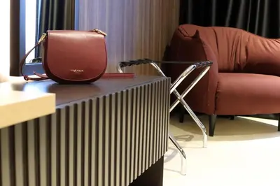 a purse sitting on top of a table next to a chair at Superior Woodside Residences & Spa Kopaonik in Kopaonik