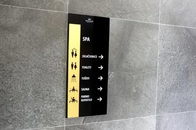 a black and yellow sign on a wall at Superior Woodside Residences & Spa Kopaonik in Kopaonik