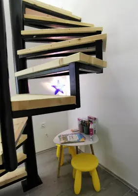 a bunk bed with a table and a stool at Kod Dede Brzece in Brzeće