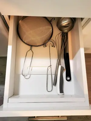 a drawer in a cabinet filled with utensils at Kod Dede Brzece in Brzeće