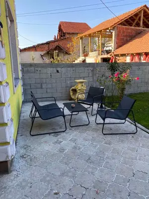 a group of chairs and a table on a patio at Apartman Zivic in Berilovac