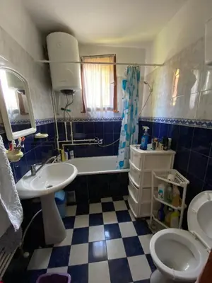 a bathroom with a sink and a toilet and a tub at Apartman Zivic in Berilovac