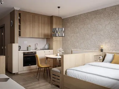 a bedroom with a bed and a table and a kitchen at Xenon Apartments in Kopaonik
