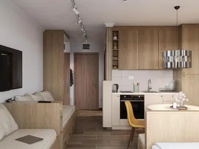 a kitchen and living room with a couch and a table at Xenon Apartments in Kopaonik