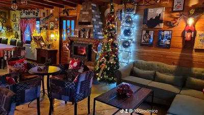 a living room with a christmas tree and a couch at Odmaraliste Kod Miće Apartman 4 in Krušar