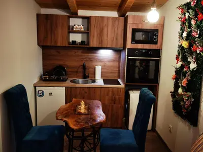 a small kitchen with a table and chairs in a room at Odmaraliste Kod Miće Apartman 4 in Krušar