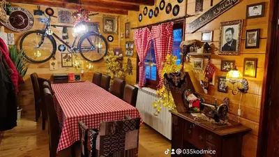 a restaurant with a table and a bike on the wall at Odmaraliste Kod Miće Apartman 4 in Krušar