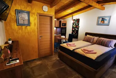 a bedroom with a bed with two pink towels on it at Odmaraliste Kod Miće Apartman 4 in Krušar