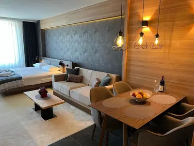 a living room with a couch and a table at Woodside Kopaonik 416 in Kopaonik
