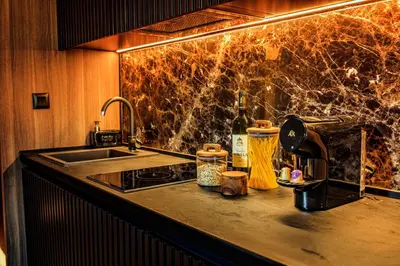 a kitchen with a sink and a counter top with a sink at Woodside Kopaonik in Kopaonik