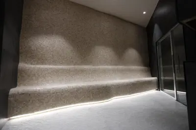 a room with a staircase with a light on the wall at Woodside Kopaonik in Kopaonik
