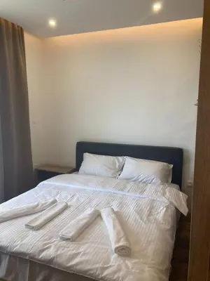 a white bed with two white towels on it at Kopaonik presidentKop apartman in Kopaonik