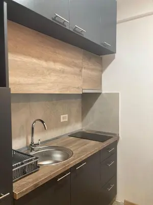 a kitchen with a sink and a counter top at Kopaonik presidentKop apartman in Kopaonik