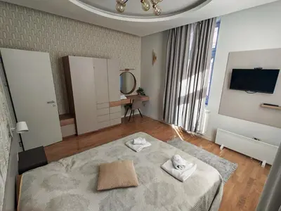 a room with a bed with two towels on it at KONDOR apartmani in Vrnjačka Banja