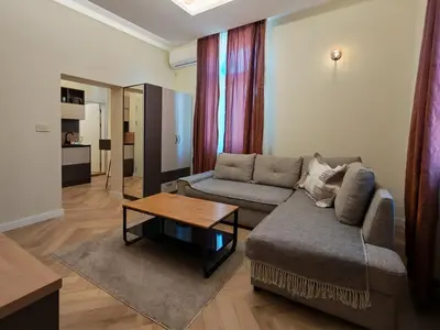 a living room with a couch and a table at KONDOR apartmani in Vrnjačka Banja