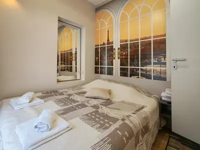 a bedroom with a bed with two towels on it at KONDOR apartmani in Vrnjačka Banja