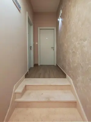 an empty hallway with stairs and a door at KONDOR apartmani in Vrnjačka Banja