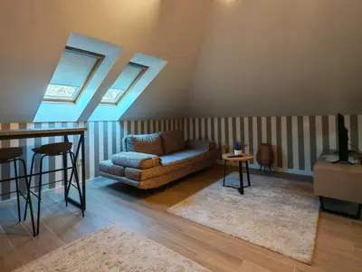 a living room with a couch and a table at KONDOR apartmani in Vrnjačka Banja