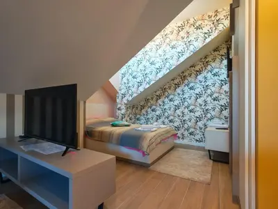 a bedroom with a bed and a tv in it at KONDOR apartmani in Vrnjačka Banja