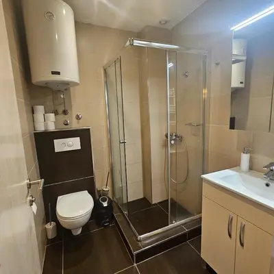 a bathroom with a shower and a toilet and a sink at VS Apartman , Hotel Župa Kopaonik in Kopaonik