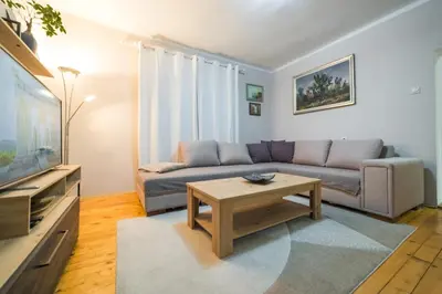 a living room with a couch and a coffee table at Petra Guest House in Pirot