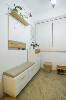 a kitchen with white cabinets and a window at Petra Guest House in Pirot