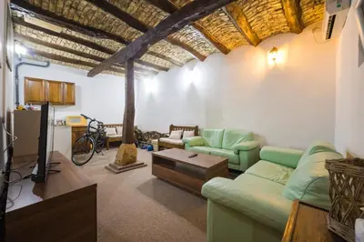 a living room with a couch and a tv at Petra Guest House in Pirot