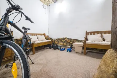 a bike parked in a room with two beds at Petra Guest House in Pirot