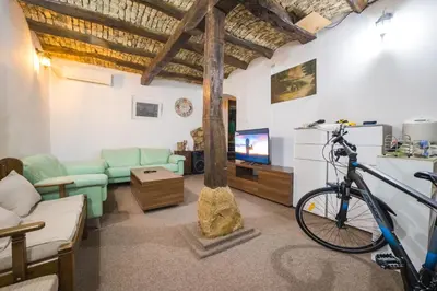 a bike parked in a living room with a tv at Petra Guest House in Pirot