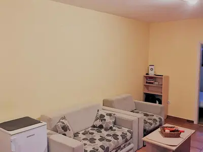 a living room with a couch and a chair at Apartman Snezanka Kopaonik in Kopaonik