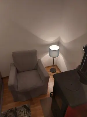 a living room with a chair and a lamp at Udahni prirodu in Raška