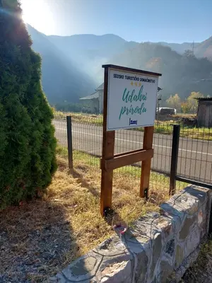 a sign in front of a fence next to a field at Udahni prirodu in Raška