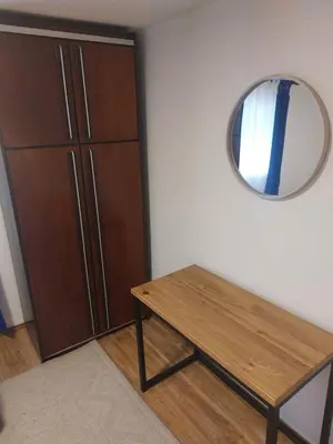a room with a wooden table and a mirror at Udahni prirodu in Raška