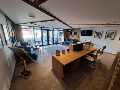 a living room with a large wooden table and chairs at LUX Apartment STEVANOVIC A86 in Kopaonik