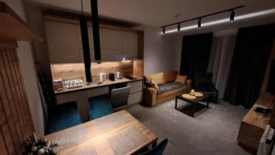 a living room with a couch and a table at LUX Apartment STEVANOVIC A86 in Kopaonik