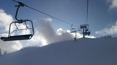 a ski lift with snow on the side of a mountain at LUX Apartment STEVANOVIC A86 in Kopaonik