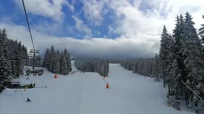 a ski lift with people skiing down a snow covered slope at LUX Apartment STEVANOVIC A86 in Kopaonik