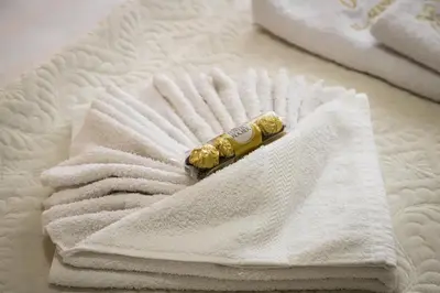 a banana laying on a pile of towels on a bed at Apartman Marić Raj in Vrnjačka Banja