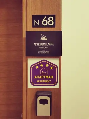 a door with a sign that readsarma kitchenowment at Apartman Laura in Kopaonik