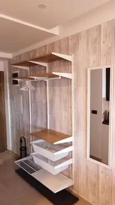a book shelf in a room with a mirror at Apartman Laura in Kopaonik