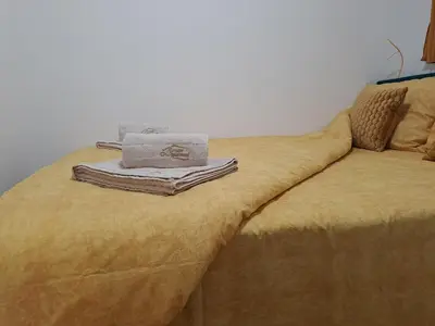 a bed with towels and boxes on top of it at Dream Apartment in Vrnjačka Banja
