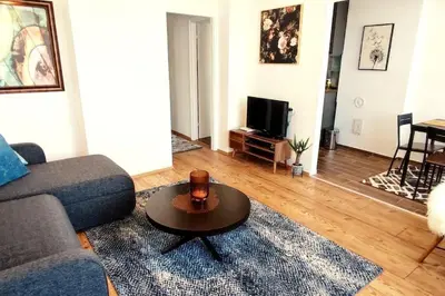 a living room with a couch and a coffee table at Tizza apartment - Modern flat above the city center in Niš