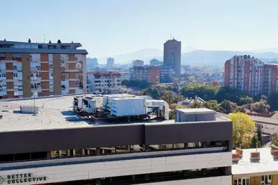 a view of a city with buildings and trees at Tizza apartment - Modern flat above the city center in Niš