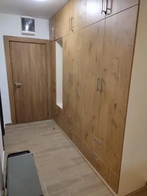 a room with wooden cabinets and a door at Twin mountain in Kopaonik