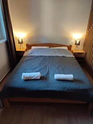 a bedroom with a bed with two towels on it at Twin mountain in Kopaonik